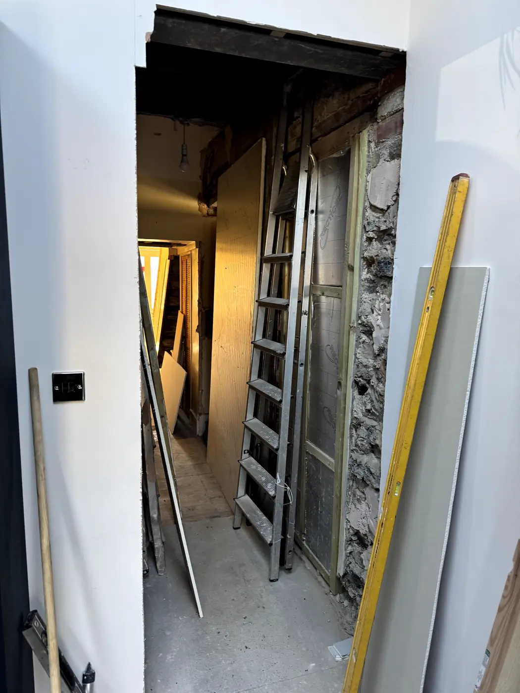 Door opening under construction, ladder and insulation boards in place