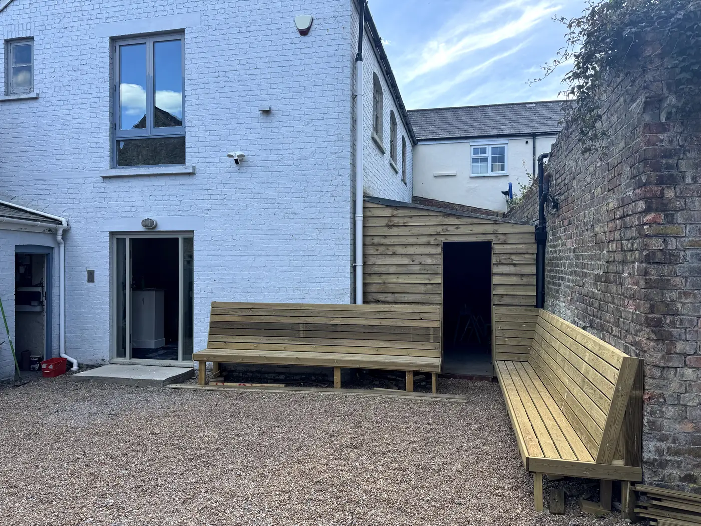 Deck sub-frame joists being built beside patio doors